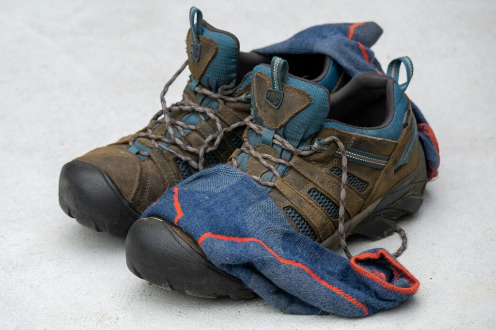 A pair of rugged hiking shoes with worn wool socks, showcasing adventure and comfort.