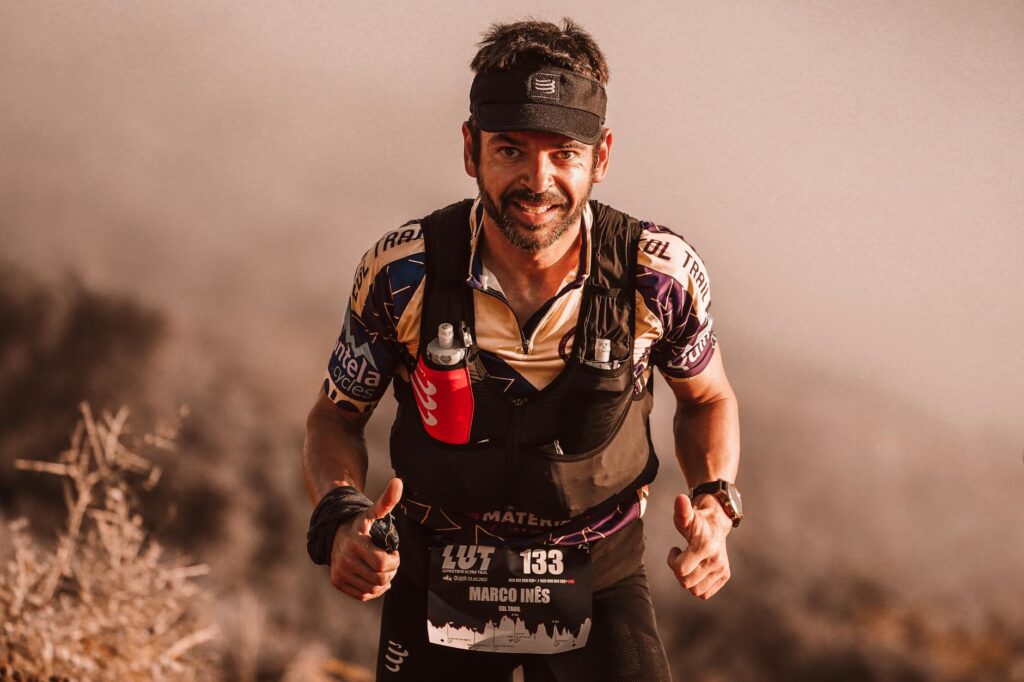 Determined trail runner participating in a race, showing perseverance and athleticism.